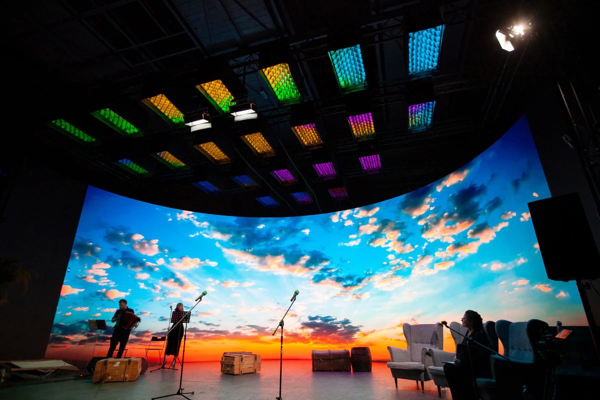 An event stage with a sunset sky on the LED wall