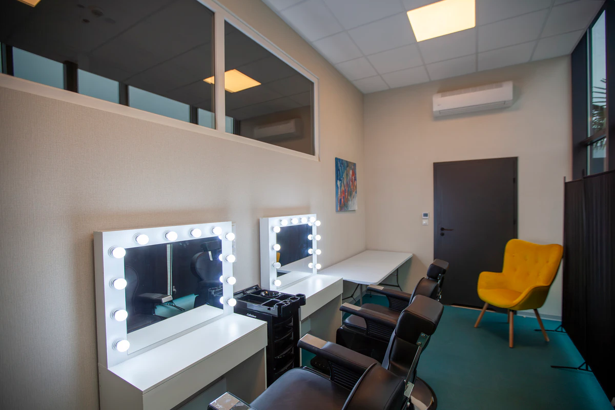 Dressing room with make-up stations and lit mirrors