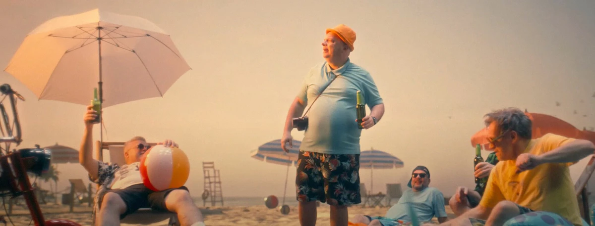 Music video shot: musicians on a beach with an umbrella