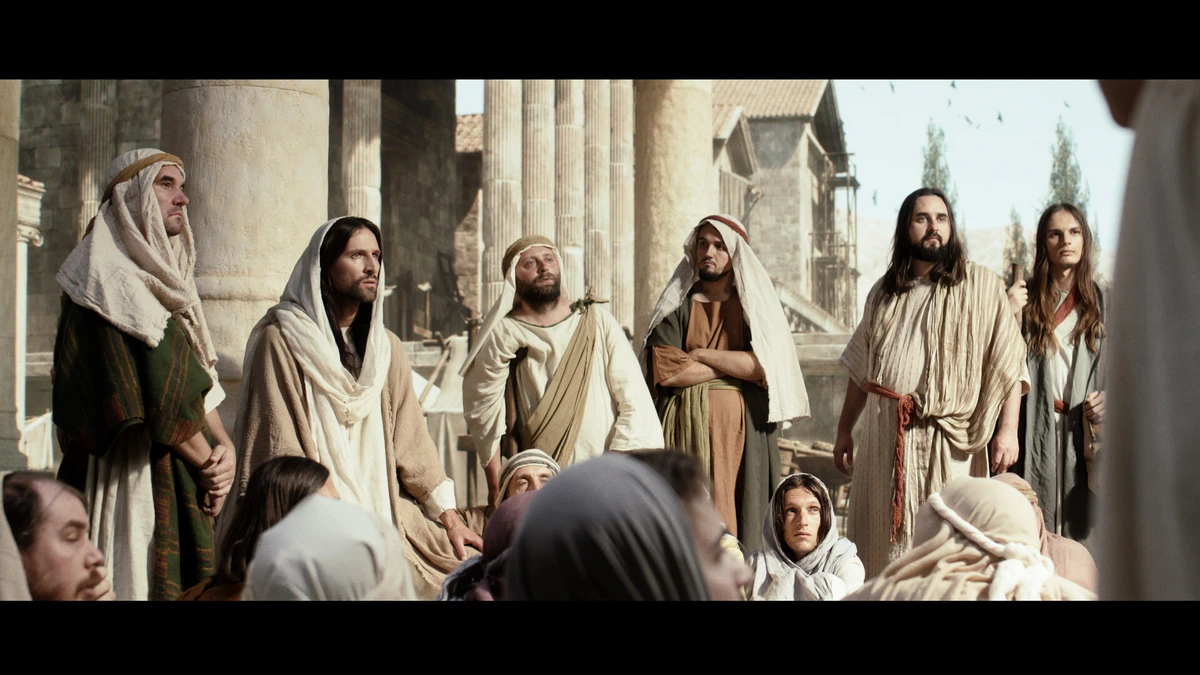 Shot: a crowd in period costume in an ancient city
