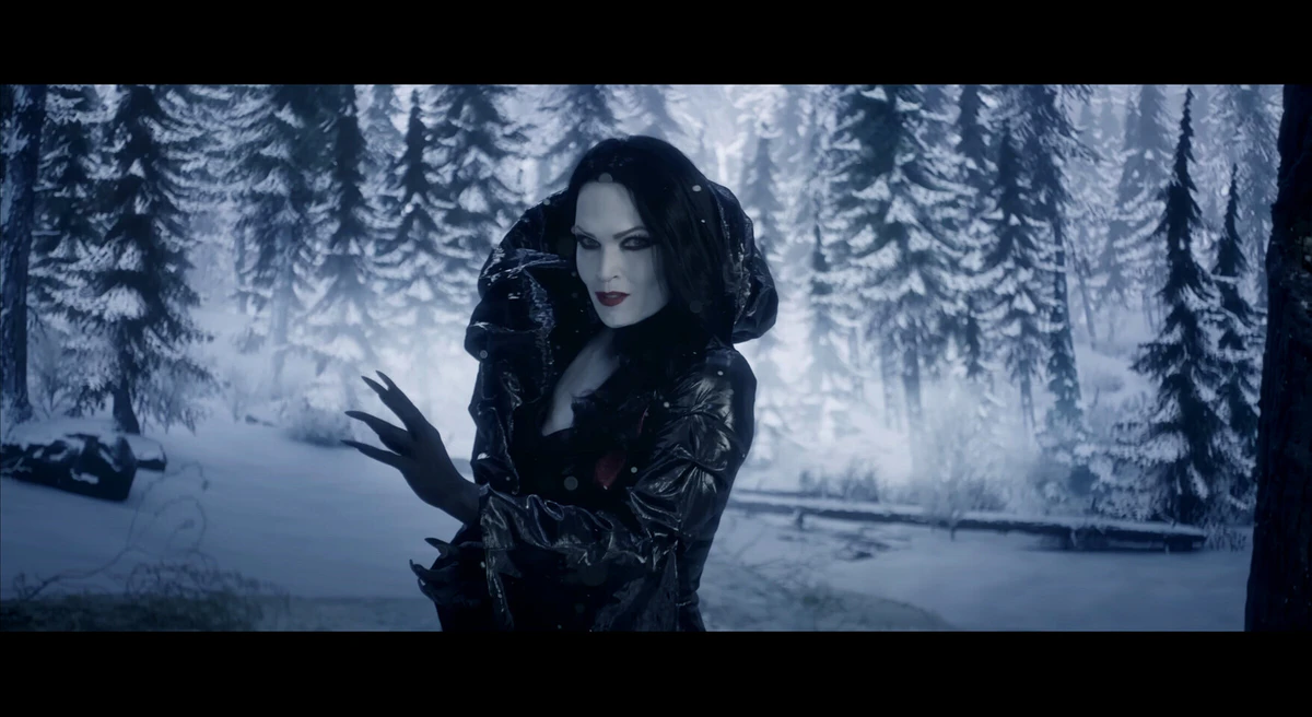 Shot: a woman in a black coat in a winter forest